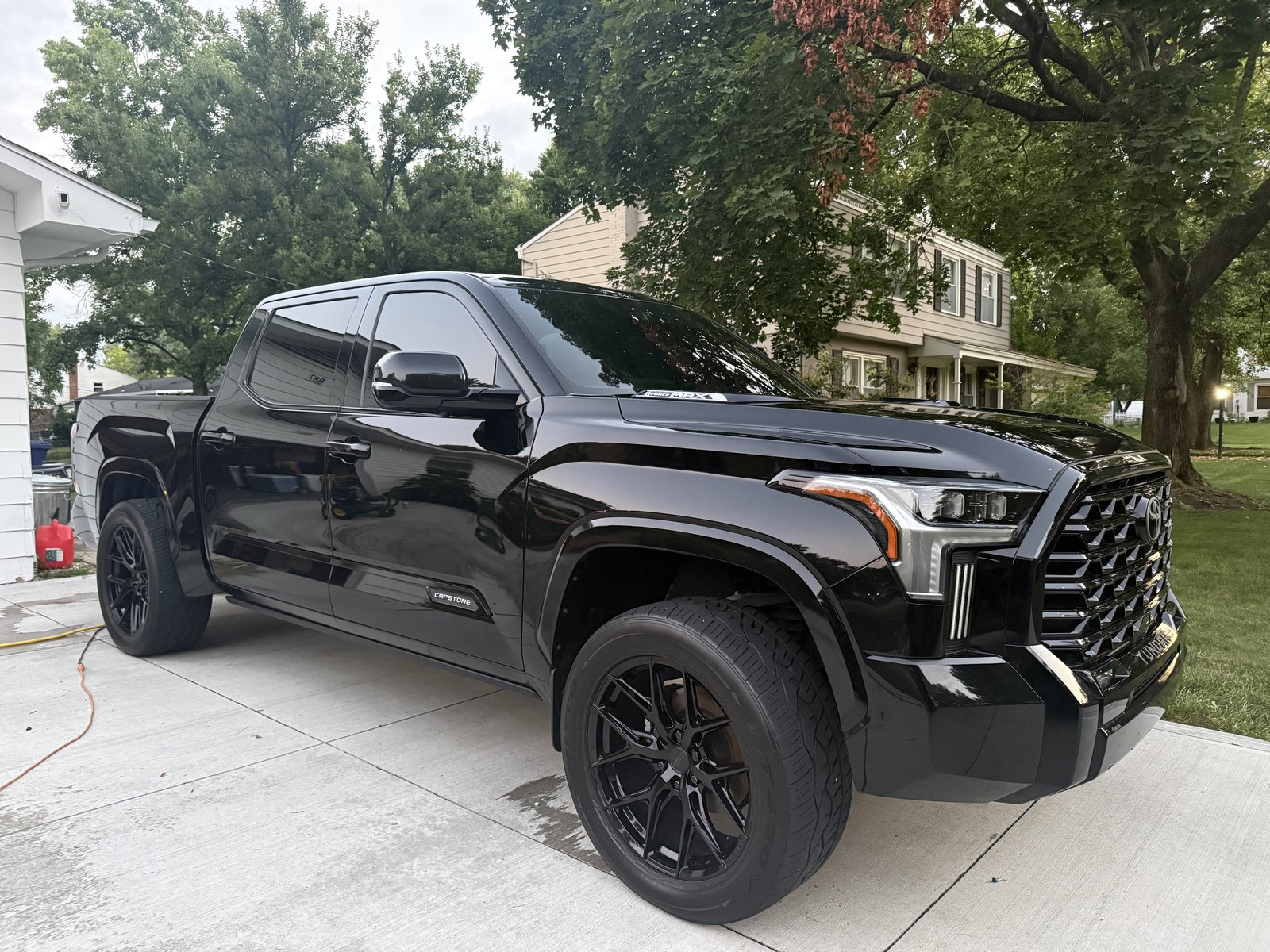 Black truck exterior after detailing, driveway view